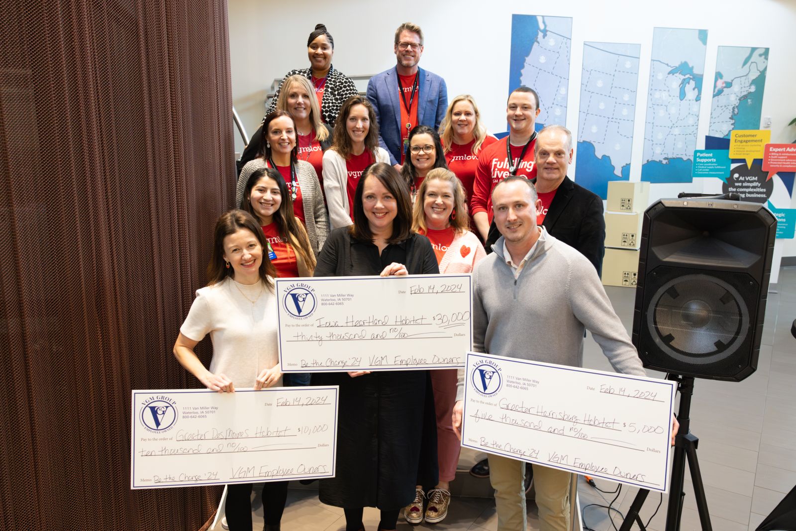 VGM employee owners holding a large check